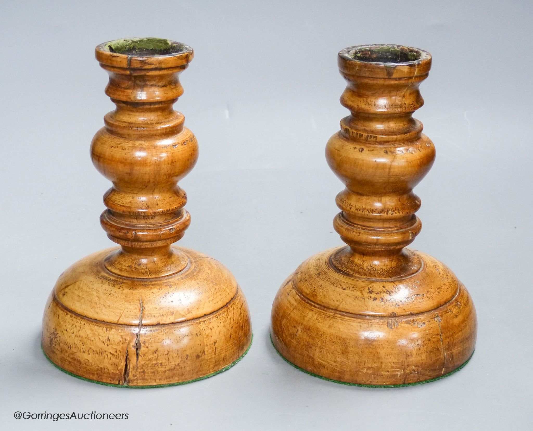 A pair of turned Treen candlesticks, height 17cm